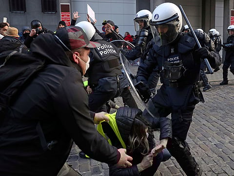 Anti riot policemen clash with protestors during a protest of the yellow jackets in Brussels, Friday, Nov. 30, 2018. The demonstrators are protesting against rising fuel prices.