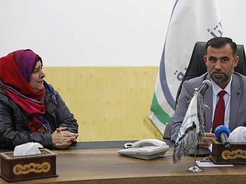 Bassam Sahiouni (R), an official from the local rebel authority ruling Syria's Idlib province, speaks during a press conference next to Nancy Roxana Papa, an 54-year-old Argentinian woman who was recently released after being kidnapped since 2016, at the Bab Al Hawa crossing with Turkey on October 30, 2018 ahead of being handed over to Turkish authorities.