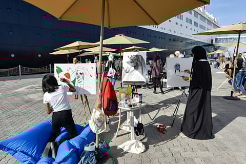 Artists at the National Day Art Festival yesterday at the Queen Elizabeth 2. Organised by ZeeArts, the festival that celebrates National Day with live paintings was launched in 2011.