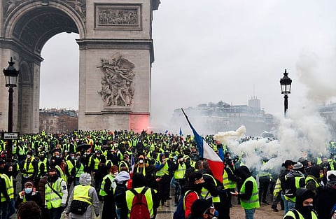 Demonstrators gather at the Arc of Triomphe in Paris during a protests on December 1.