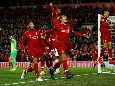 Liverpool's Divock Origi celebrates scoring with Virgil van Dijk and team mates.