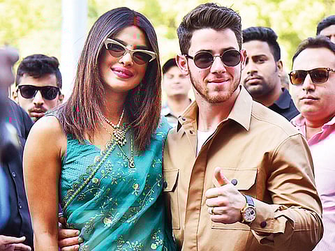 Priyanka Chopra and Nick Jonas pose outside the airport in Jodhpur in the desert state of Rajasthan, India.
