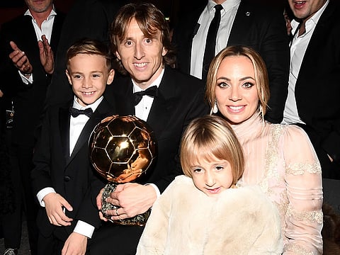 Croatian midfielder Luka Modric (C), his wife Vanja (R), his son Ivano and his daughter Ema pose with the trophy after the 2018 FIFA Ballon d'Or award ceremony at the Grand Palais in Paris on December 3, 2018.