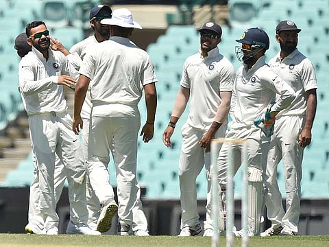 File photo: India's captain Virat Kohli (left) and the team celebrate the wicket of Australia's Harry Nielsen on the fourth day of the tour match against Cricket Australia XI at the SCG in Sydney on December 1, 2018.
