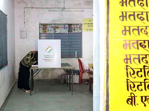A voter marks her ballot at a polling booth for India's Madhya Pradesh state assembly election in Bhopal on November 28, 2018.
