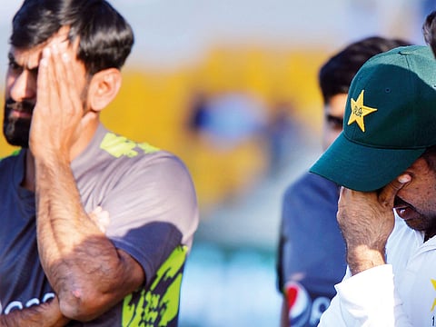 Dejected Pakistan captain Sarfraz Ahmad (right) reacts after the third and final Test match which they lost to New Zealand in Abu Dhabi on Friday.