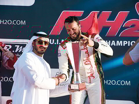 Shaikh Mohammad Bin Sultan Bin Khalifa Al Nahyan, Vice- President and CEO of Abu Dhabi International Marine Sports Club hands the Grand Prix of Abu Dhabi trophy to Al Qamzi