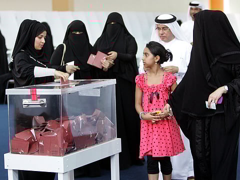File: A family cast their vote at the polling station at the Exhibition Centre at Ras Al Khaimah.