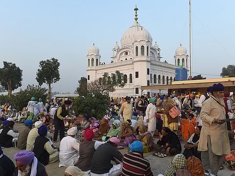 Sikh Pilgrims eat food in front of Kartarpur Gurdwara Sahib after a groundbreaking ceremony for the Kartarpur Corridor.