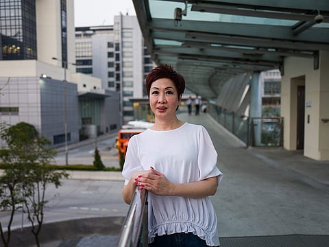 Dora Lai, Cathay Pacific Flight Attendants Union leader and a cabin manager, poses during an interview with AFP in Hong Kong.