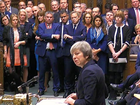 Pound slips to 18-month low as May pulls Brexit vote