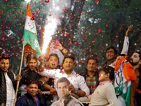 Congress party supporters celebrate initial poll results in Delhi.
