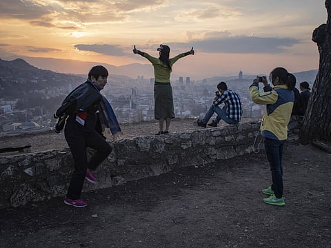 Tourists enjoy a sunset over Sarajevo, the capital of Bosnia and Herzegovina.