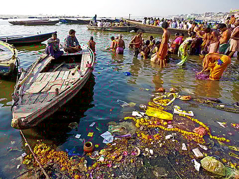 People taking ritual bath in the river Ganga in the holy city of Varanasi, India.