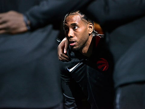 In this Tuesday, Nov. 27, 2018, file photo, Toronto Raptors forward Kawhi Leonard huddles with teammates before an NBA basketball game against the Memphis Grizzlies in Memphis, Tennessee.