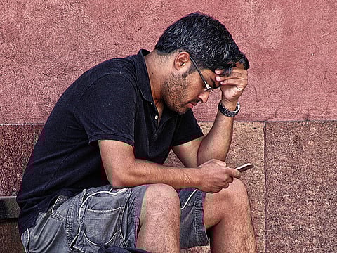 A man looking at his smartphone.