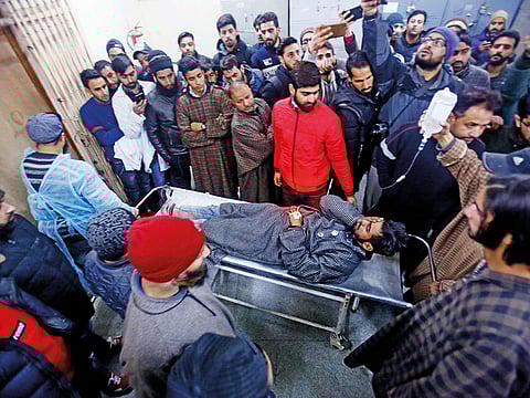 People carry an injured civilian on a stretcher inside a hospital in Srinagar, Indian-administered Kashmir, following clashes.