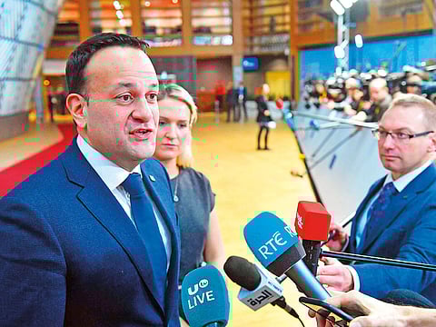 Ireland's Prime Minister Leo Varadkar (L) speaks to the medias as he arrives in Brussels during the second day of a European Summit .