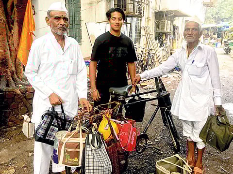 Dubai student Roshan Prem with Dabbawalas in Mumbai.