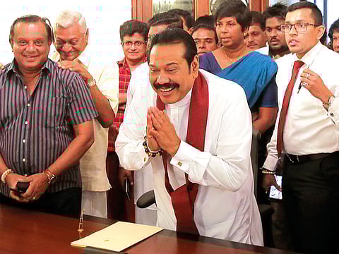 Sri Lanka’s Mahinda Rajapakse just before signing his resignation from the premiership at his home.