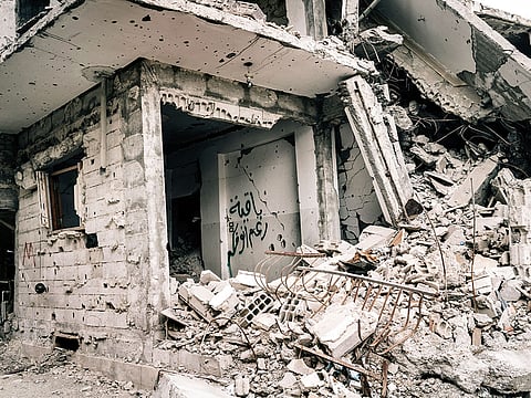 ‘Remaining in spite of you,’ says a freshly spray-painted graffiti on a wall in Raqqa, Syria.