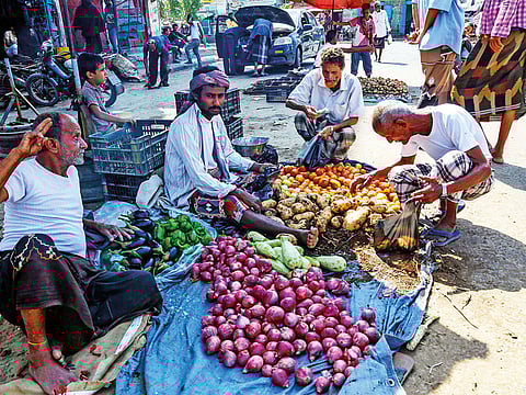 A Yemeni buys produce from a vegetable peddler at a market in the Red Sea port city of Hodeida.