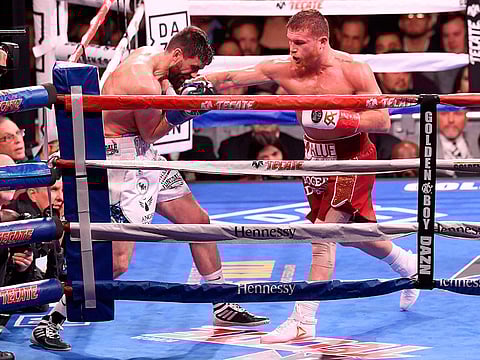 (L-R) Rocky Fielding fights Canelo Alvarez during their WBA Super Middleweight title bout at Madison Square Garden in New York City