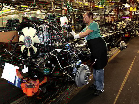 General Motors auto assembly worker works on assembling engines for Chevrolet Silverado's and GMC Sierra pickup trucks at the Flint Assembly in Flint, Michigan