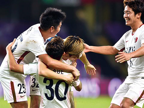 Kashima players celebrate their win against Guadalajara.