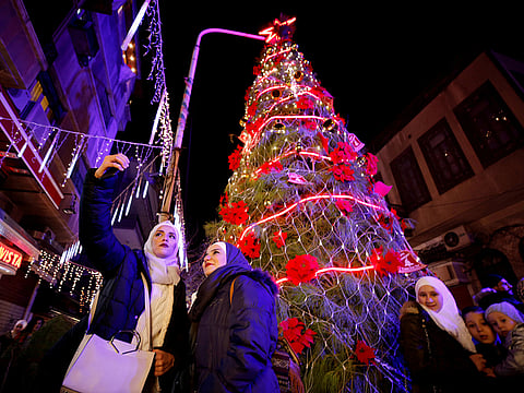 A boy sells sweets in the ancient quarter of Bab Sharqi in Damascus