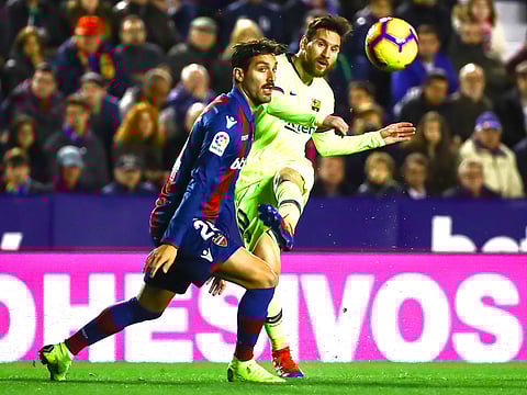 Levante's defender Jose Gomez Campana (left), in action against FC Barcelona's forward Lionel Messi (right), during their La Liga soccer match between Levante UD and FC Barcelona at Ciutat de Valencia stadium in Valencia, Spain.
