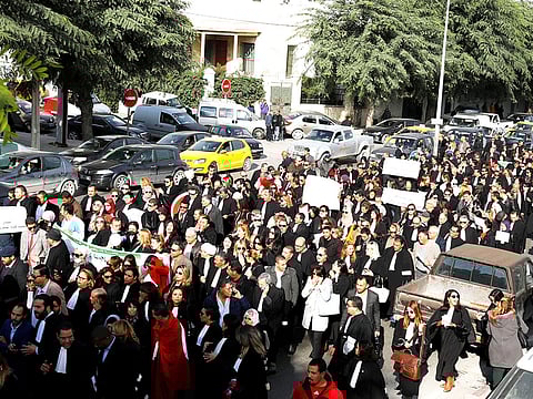 Tunisian lawyers and doctors gather as they demonstrate against the government's, near the courthouse, in Tunis, Tunisia