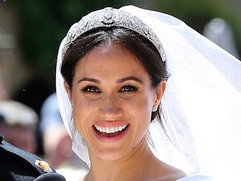 In this May 19, 2018, file photo, Meghan Markle leaves with Prince Harry after their wedding ceremony, at St. George's Chapel in Windsor Castle in Windsor, near London, England.