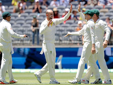 Australia's Nathan Lyon (2nd L) is congratulated by his teammates after dismissing India's Rishabh Pant on day five of the second test match between Australia and India at Perth Stadium in Perth, Australia, December 18, 2018.