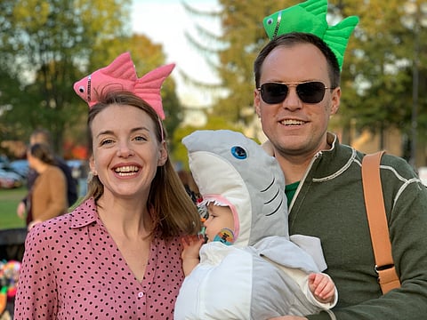Jason Simms with his wife Jillian and their daughter Fionnuala wearing a shark costume.