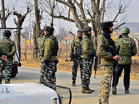 Troops stand guard outside an army camp in Pulwama, Kashmir.