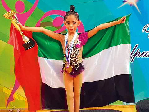 Lamia Tareq Al Farsi on the podium after winning a bronze at the Novogorsk Winter Rhythmic Gymnastics Cup 2018.