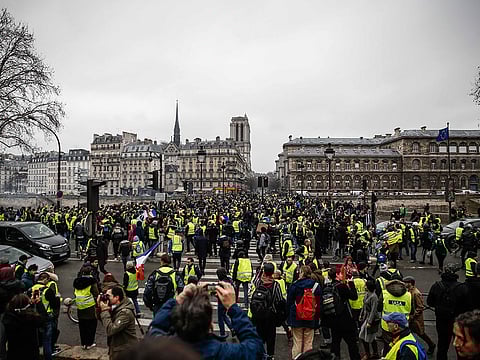A demonstrator of the French "yellow vests" (gilets jaunes) gather near the ile de la Cité in central Paris on December 22, 2018 during a protest as the movement turned out in small numbers for a sixth Saturday of nationwide demonstrations.