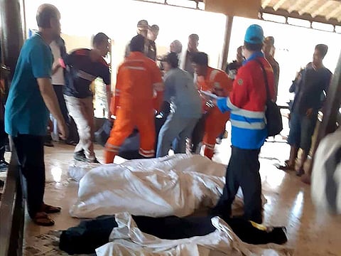 This handout from Indonesia's Social Affairs Ministry taken and released on December 23, 2018 shows bodies of victims being carried into a makeshift mortuary in Carita, after the area was hit by a tsunami on December 22 following an eruption of the Anak Krakatoa volcano.