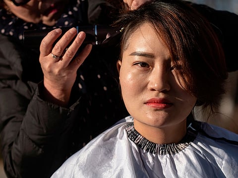 Li Wenzu has her head shaved to protest the detention of her husband and Chinese human rights lawyer Wang Quanzhang