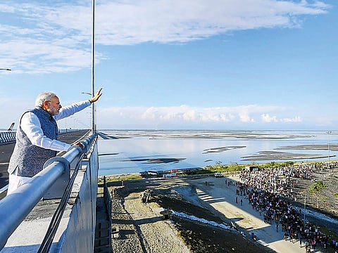 Prime Minister Narendra Modi waves at people from the Bogibeel Bridge, the longest rail-cum-road bridge on Brahmaputra river, after it was inaugurated by him, in Dibrugarh, Tuesday, December 25, 2018.