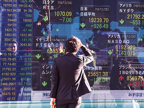 A man looks at an electronic stock board outside a securities firm in Tokyo, Japan, on Tuesday.