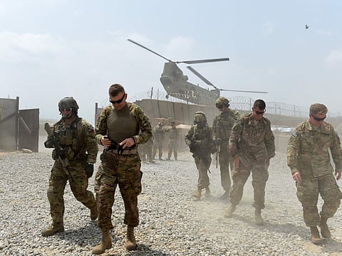 US army soldiers walk as a NATO helicopter flies overhead at coalition force Forward Operating Base (FOB) Connelly in the Khogyani district in the eastern province of Nangarhar (File)