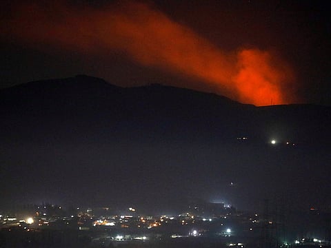 Smoke rises past a mountain as seen from Damascus countryside, Syria December 25, 2018.