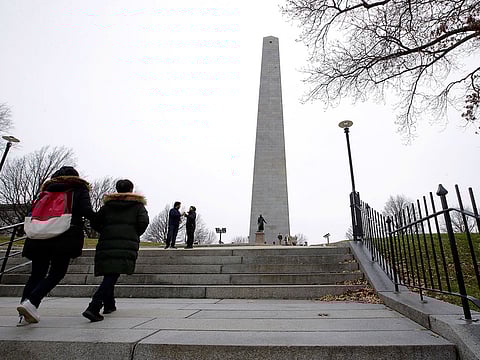 Visitors approach the Bunker Hill Monument, Monday, Dec. 24, 2018, in Boston. The historic site, erected to commemorate the Revolutionary War Battle of Bunker Hill, and run by the National Park Service, was closed Monday due to a partial federal government shutdown.