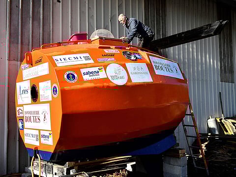 Jean-Jacques Savin, a former paratrooper, 71, works on the construction of a ship made from a barrel at the shipyard in Ares, southwestern France.