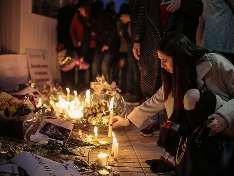 Moroccans lay flowers and messages during a candlelight vigil outside the Norwegian embassy in Rabat for two Scandinavian university students who were killed in a terrorist attack in a remote area of the Atlas Mountains, Morocco, Saturday, Dec. 22, 2018.