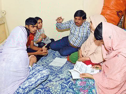 Asghar Hussain with his family in Sharjah last Wednesday. Thanks to Amnesty they now hold valid UAE visas.