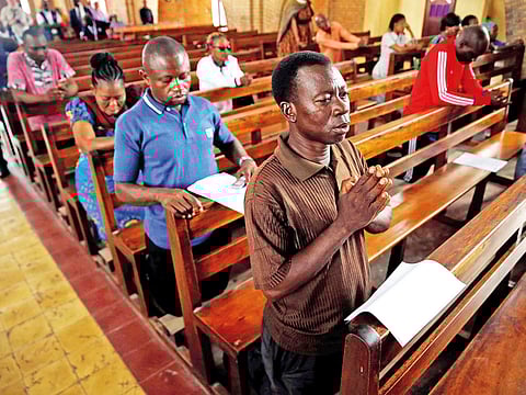 Congregants pray during a mass for a peaceful election at the Notre Dame de Kinshasa cathedral in Kinshasa on Saturday.