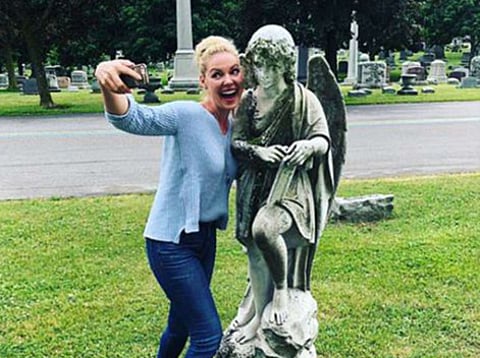 Katherine Heigl takes a selfie in a cemetary